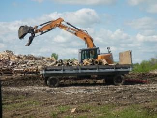 Burn pad preparation for thermal treatment of explosively contaminated sewer pipe