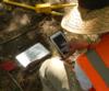 UXO Field Personnel entering data on a ruggedized table