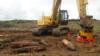 RFI's Robotic JD330 Excavator with clawed magnet consolidating within a submunition area